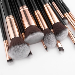 Close-up of 12pcs black makeup brush set with rose gold ferrules and soft bristles