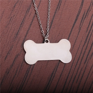 Minimalist bone shaped stainless steel pendant necklace with a polished silver finish