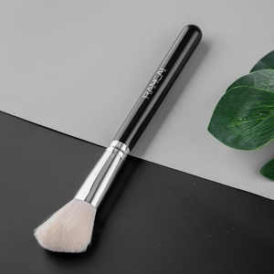 Detail of RANCAI angled contour brush with black handle and soft white bristles