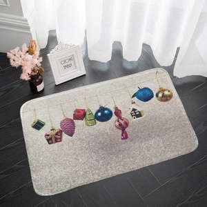 Macro view of Christmas flannel mat with hanging holiday ornaments on dark wood floor