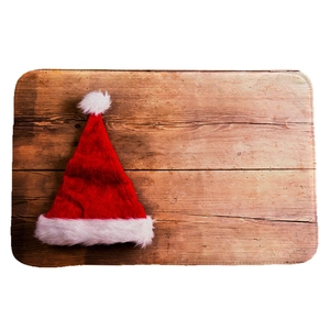 Classic red flannel Christmas hat with plush white trim on a rustic brown wood background