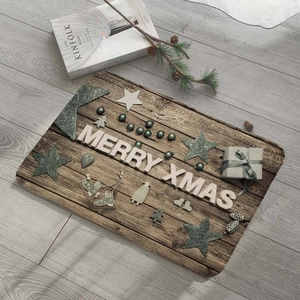 Detail view of a rustic Merry Xmas wooden mat with festive ornaments and pine cones