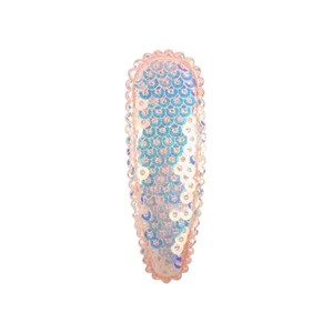 Pink sequin bow hair clip with iridescent scales and pearl bead edge on white background