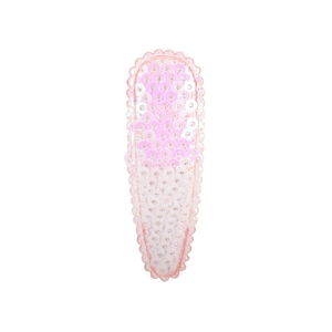 Close-up of pink sequin hair clip with wave edges and shiny glitter texture on white background