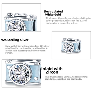 Macro detail of 925 sterling silver camera charm with blue enamel and sparkling zircon
