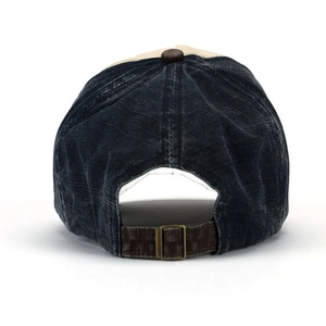 Detail view of vintage navy denim baseball cap with adjustable brown strap and metal buckle