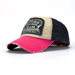 Detail of vintage distressed racing baseball cap with pink contrast and worn edges