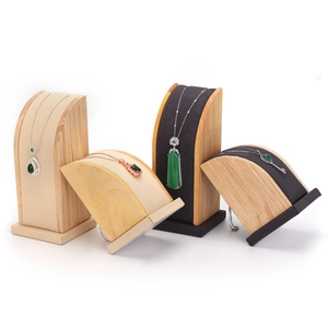 Wooden necklace display stands with beige and dark grey linings on white background