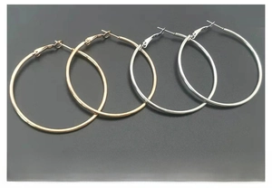 Detail of 18K gold plated and silver stainless steel hoop earrings with pin closure