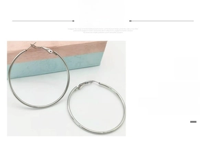 Detailed view of large silver stainless steel hoop earrings with secure clasp closure
