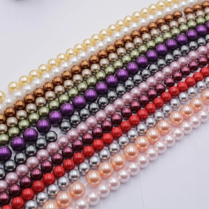 Macro shot of colorful glass pearl beads for jewelry making in a diagonal arrangement