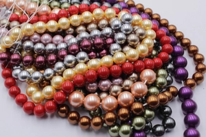 Macro shot of colorful glass pearl beads for DIY jewelry making in various vibrant shades