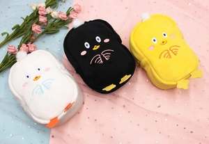 Detailed view of plush penguin organizers in white, black and yellow with soft fur texture