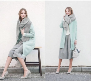 Fashionable styling with grey chunky knit scarf and mint green long coat ensemble