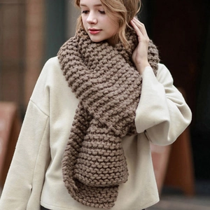 Close-up of thick chunky knit coffee brown scarf showing warm wool texture