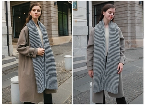Close-up of thick grey ribbed knit texture on a warm winter scarf for couples