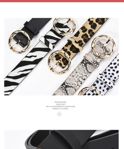 Close-up of stylish women wide belts in leopard, snake and zebra patterns with gold rings