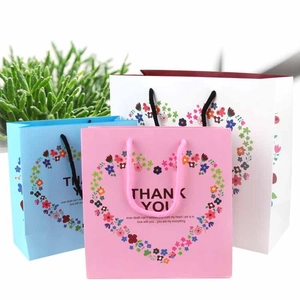 Floral gift bags in pink, blue, and white with Thank You print and heart patterns