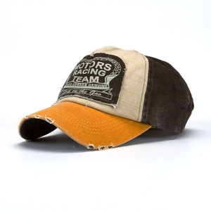 Detail of vintage tri-color baseball cap with retro Motors Racing Team patch and canvas texture
