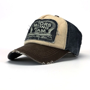 Detail of vintage racing baseball cap with multicolor patchwork and frayed motors patch