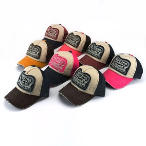 Detail of vintage racing team patches on distressed cotton mesh baseball caps