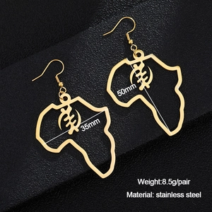 Macro shot of 50mm gold stainless steel Gye Nyame African map dangle earrings on leather