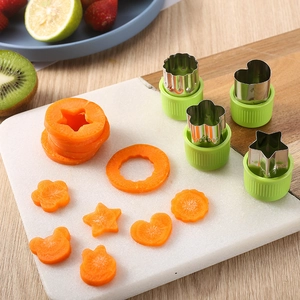 Stainless steel vegetable cutters with green handles for star, heart, and flower shapes