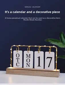 Detail of wooden perpetual calendar with iron frame and warm LED string lights