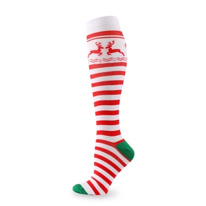 Detail of Christmas compression socks with red-white stripes and green reindeer patterns