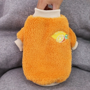 Detailed view of warm orange pet sweater with soft coral fleece and lemon embroidery