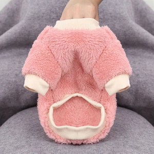 Close-up of pink fluffy pet sweater showing thick plush fabric and elastic ribbed cuffs