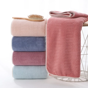 Thick absorbent coral fleece bath towels with geometric waffle texture in multiple colors