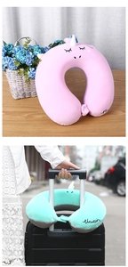 Detail of unicorn neck pillow showing soft plush fabric and luggage strap attachment