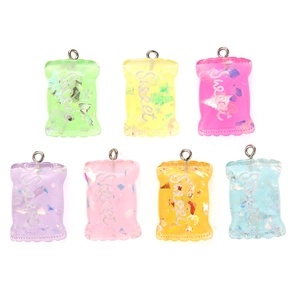 Macro shot of 7 colorful translucent resin candy bag pendants with Sweet engraving