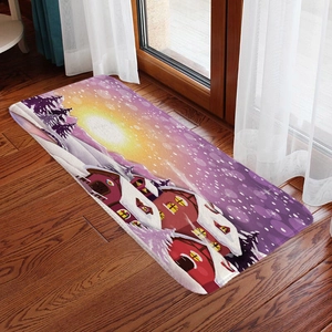 Detailed view of Christmas flannel mat with winter cabin scene on dark wood floor