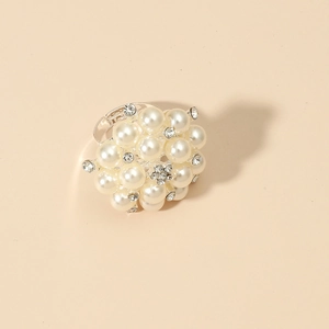 Detailed close-up of adjustable silver flower ring with white pearls and sparkling rhinestones