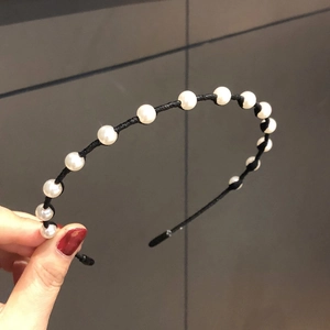 Elegant thin black metal headband with white pearls for women in minimalist style