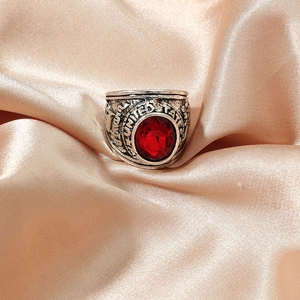 Vintage silver eagle ring featuring a large oval red gemstone and United States engraving