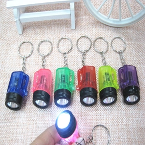 Detail view of colorful mini LED flashlight keychains with bright white light feature