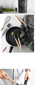 Detail of durable grey silicone kitchen utensils with ergonomic wooden handles