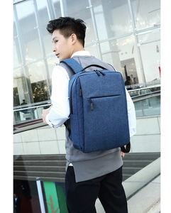 Blue waterproof laptop backpack on model with focus on ergonomic straps and side view