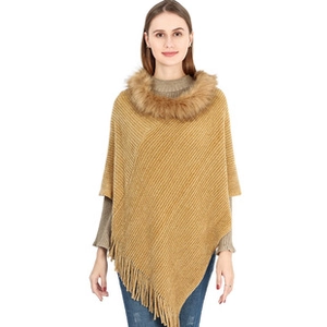 Detail view of the soft faux fur collar and textured knit fabric on camel poncho