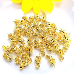 Bulk 18K gold-plated crown pendant connectors with micro-pave crystals on white plate