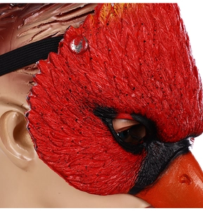 Detailed close-up of the red bird mask showing intricate feather texture and orange beak