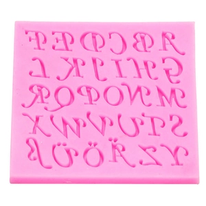 Detailed top view of pink silicone mold featuring full A-Z alphabet and symbols