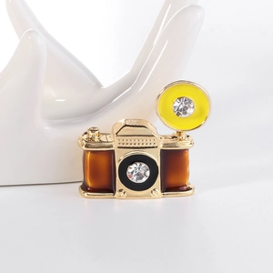 Vintage camera brooch in gold alloy with brown enamel and sparkling crystal accents