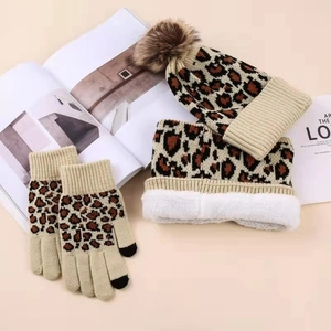 Three-piece leopard print winter set with pompom hat, plush scarf, and touchscreen gloves