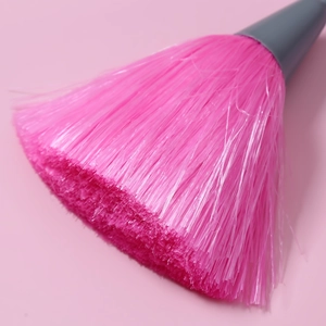 Detail of pink synthetic fiber bristles and grey handle of the keyboard cleaning brush