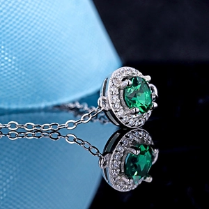 Elegant 925 silver necklace featuring a round emerald green gemstone with halo diamonds
