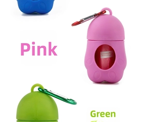 Detail view of colorful bone-shaped pet waste bag dispensers with metal carabiner clips